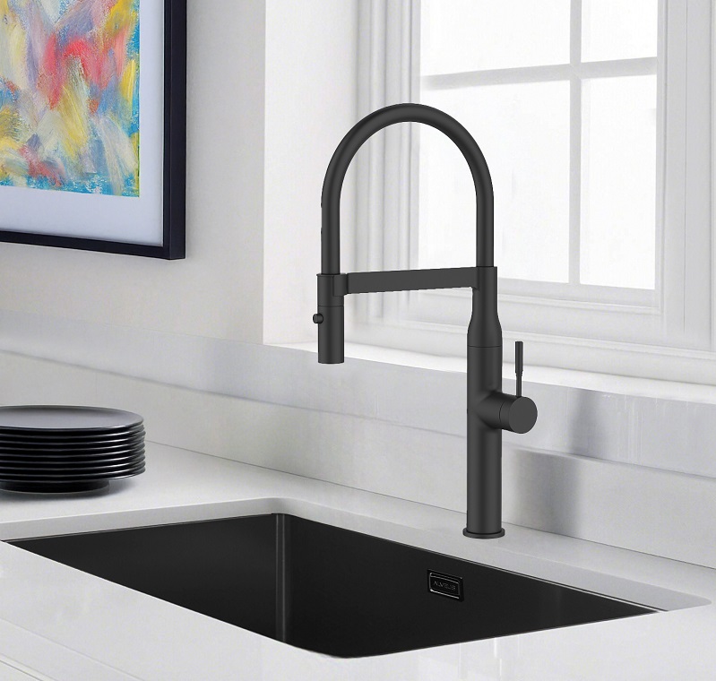 Grifo de cocina blanco y fregadero de acero inoxidable en una cocina blanca con un fondo verde o naturaleza visible a través de la ventana