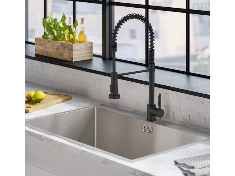 Elegant black kitchen faucet with a professional, industrial-style design, paired with a modern stainless steel sink in a bright kitchen setting, featuring a marble countertop and a window overlooking an urban landscape